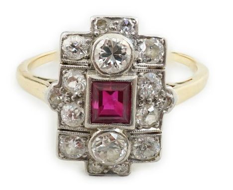 A 1920's gold and millegrain set ruby and diamond cluster dress ring, of quatrefoil shape, size N, gross weight 3.2 grams.  A