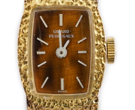 A lady's Girard Perregaux 18K yellow gold wrist watch, with tiger's eye quartz dial, white hands and markers, on integral tex