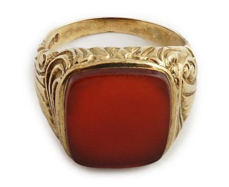 A 1970's Victorian style 9ct gold and carnelian set signet ring, with carved shoulders, size R, gross weight 8.9 grams.  Mino