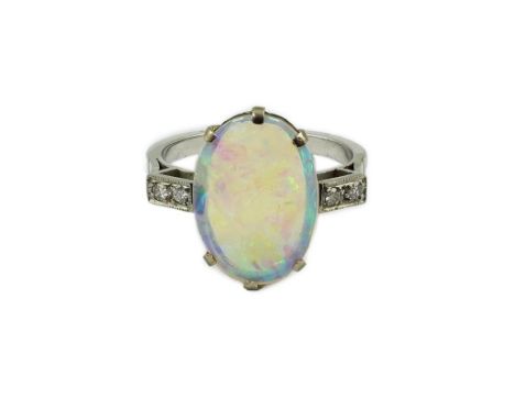 A white gold? and single stone oval cabochon opal set ring, with four stone diamond set shoulders, size O, gross weight 4.8 g