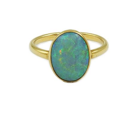 An 18ct gold and single stone oval cabochon opal set ring, size K, gross weight 3.9 grams.  Stone surface could do with a re-