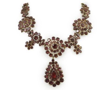 A good 18th century gilt metal and foil backed garnet cluster drop necklace, in original box, set with various cut stones inc