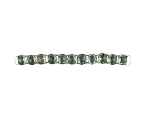 A rare 18th century 'Queen Anne' gilt metal and foil backed aquamarine paste bracelet, set with eleven facet cut oval stones,