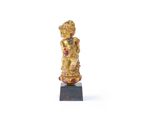 A Balinese gem-set gold coloured chased kris hilt, late 19th century, chased gold sheet over resin, with corundum and paste s
