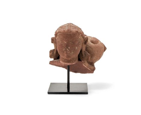 A Stone carving of a Female Deity, Central Indian, 11-12th century, the bespoke stand with old Spink label now torn, approxim
