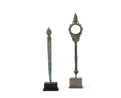 A Cambodian ceremonial staff or baton, 12-13th century, with pointed  finial and segmented handle and central circular apertu