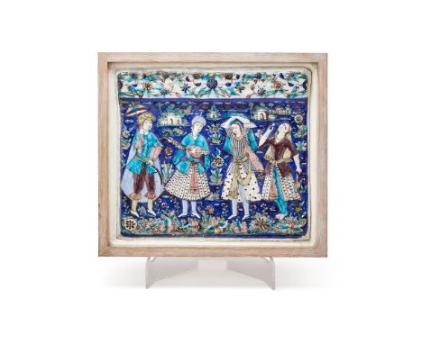 A Large Qajar Moulded Tile, Persia, 19th century, underglaze painted fritware, depicting a prince watching two female dancers