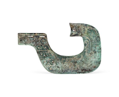 A Chinese bronze ceremonial axe, yue, the C-shaped blade cast in relief with a stylised tiger, the tang incised with swirl mo