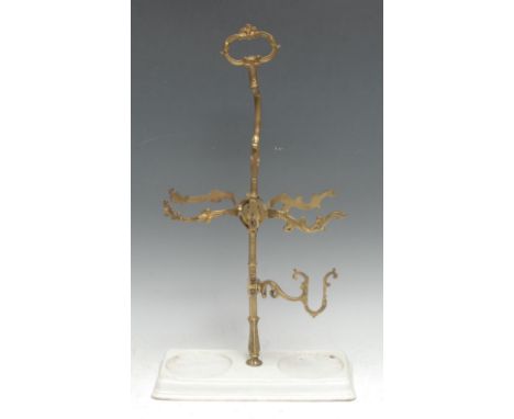 An unusual early 20th century gilt metal wine bottle stand/cradle, sprung mechanism, ceramic base, 44.5cm high 