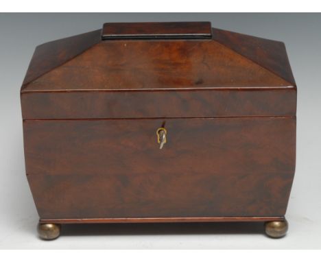 An early Victorian mahogany sarcophagus tea caddy, hinged cover enclosing a pair of of lidded compartments, gilt brass bun fe