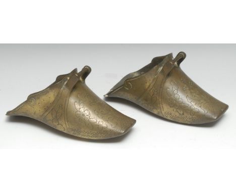 A pair of South American brass Conquistador stirrups, cast and chased with flowers, stiff leaves and scales, 26cm long, 19th/