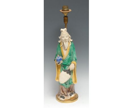 A Chinese figure, of an elder holding a peach, glazed in mottled tones of green, yellow, and blue, 31.5cm high, later mounted