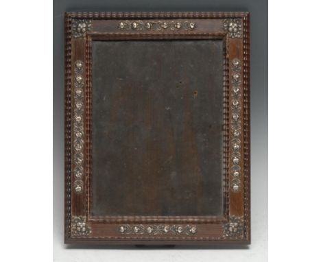 A Dutch Colonial silver mounted hardwood easel photograph frame, applied with bands of stylised flowers, wavy borders, 30.5cm