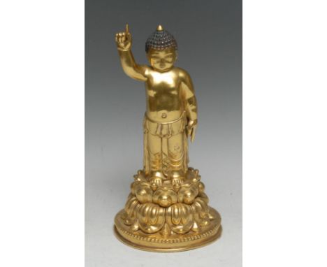 Sino-Tibetan School, a gilt bronze or copper alloy figure, the infant Buddha, he stands, upon a lotus, pointing towards the h