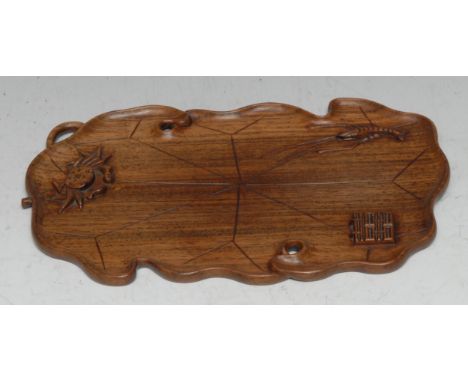 A Chinese hardwood scholar's tray, carved in relief with a cray, a crayfish and seal, 21.5cm wide 