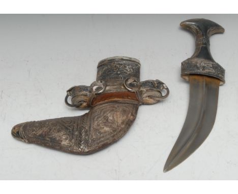 A Middle Eastern silver mounted jambiya, 17cm curved blade, horn grip, the hilt and scabbard applied with filigree and chased