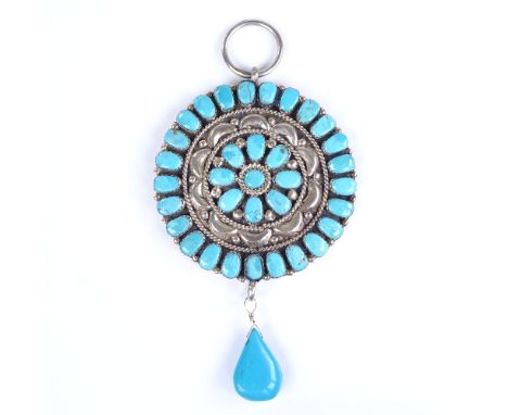 A large Vintage turquoise and unmarked silver circular pendant, possibly Mexican, with pear-shaped turquoise drop, central pa