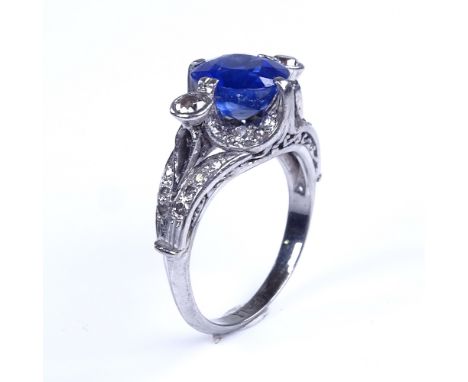 A late 20th century palladium sapphire and diamond cluster dress ring, sapphire measures: length - 8.05mm, width - 7.70mm, de