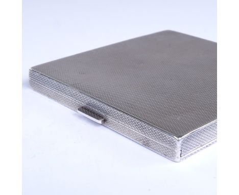 A George V Art Deco square silver cigarette case, allover engine turned decoration, with concealed hinge and gilded interior,