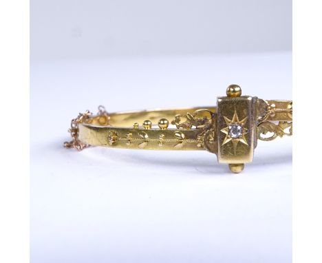 A 19th century 15ct gold and diamond Etruscan hinged bangle, internal length 55mm, internal height 43mm, 6.9gFair overall con