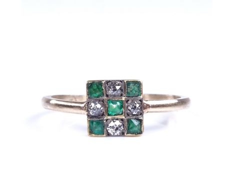 An Art Deco style unmarked gold emerald and diamond chequerboard panel ring, set with square step cut emeralds and old round 