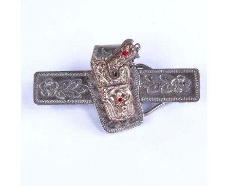 A large American novelty silver and 10ct rose gold mounted holstered pistol tie clip, with removeable red stone set gun and f