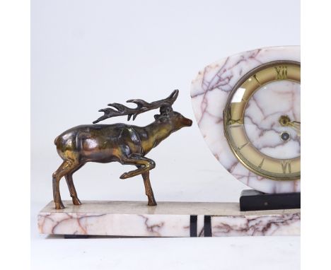 An Art Deco pink veined marble 30-hour mantel clock, surmounted by 2 spelter stags, with brass chapter ring and Roman numeral