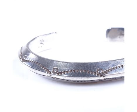 A Native American Navajo sterling silver torque bangle cuff, maker's marks L Ml, band width 8.2mm, internal dimension 60mm x 