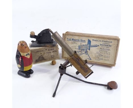 A Vintage Rene Bull Patent Toy Maxim Gun, in original box, a toy Trench Bomb Thrower, in original box, and a wooden toy noddi