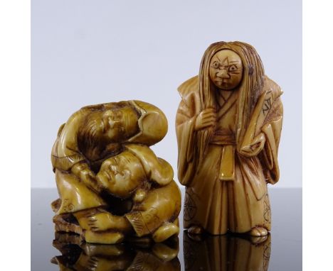 2 Japanese carved stained ivory netsuke, 1 with a rotating face, height 5cm (2) 