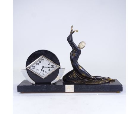 An Art Deco slate and white onyx 30-hour mantel clock, silver diamond-shaped dial with Arabic numerals, case surmounted by a 