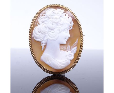 A Vintage relief carved cameo shell panel brooch, depicting female profile, in 9ct gold rope twist frame, brooch height 44.1m