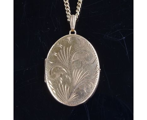 A late 20th century 9ct gold oval locket pendant necklace, on 9ct curb link chain with gold plated sterling silver magnetic c