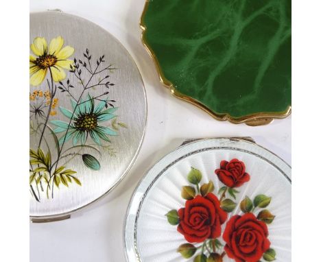 A hallmarked silver and enamel compact, decorated with red roses, Birmingham 1957, diameter 7.5cm, and 2 Stratton compacts (3