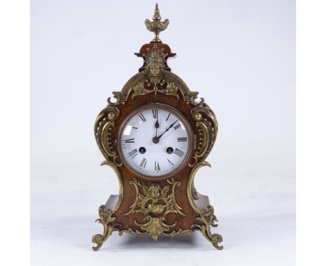 A late 19th century Rococo style walnut and brass 8-day mantel clock, white enamel dial with Roman numeral hour markers and a