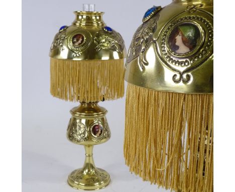 A pair of Victorian reproduction oil lamps, with relief embossed decoration, inset printed portrait plaques and tasseled shad