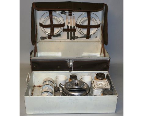 A 1930's Garrison picnic hamper for four place settings, the metal trunk opening to reveal a near complete two layer set, can
