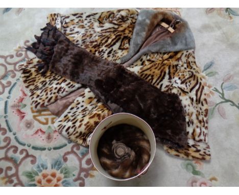 A box containing faux fur leopard print coat together with an Edna Wallace fur hat and a fur scarf 