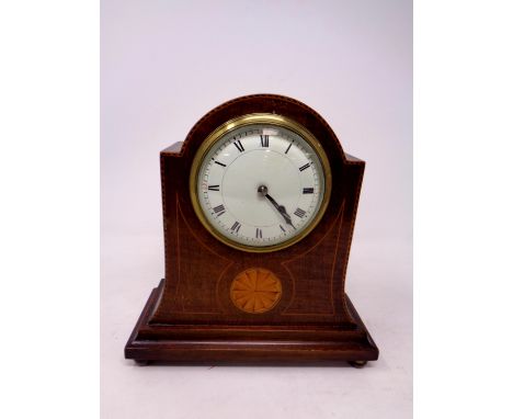 An Edwardian inlaid mahogany mantel clock with enamel dial on raised brass feet 