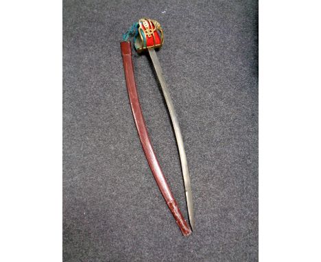 A 20th century Scottish basket hilt sword in leather scabbard (as found) 