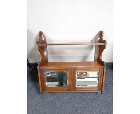 An Edwardian mahogany mirror door wall cabinet, fitted shelf above 