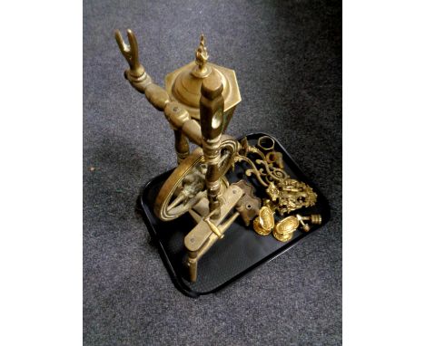 A tray containing a brass ornament of a spinning wheel, a brass lantern table lamp, wall sconces, door handles, etc 