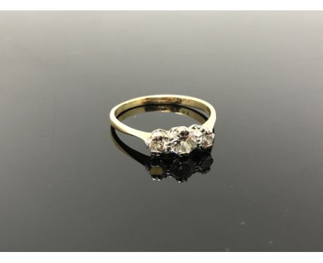 An 18ct gold and platinum three stone diamond ring, size R CONDITION REPORT: 2.7g