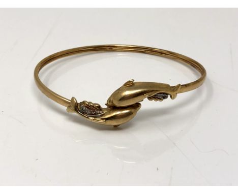 A 9ct gold dolphin bangle set with diamonds CONDITION REPORT: 7.4g