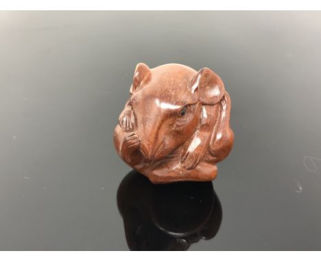 A carved hardwood netsuke  - Rat curled into a ball