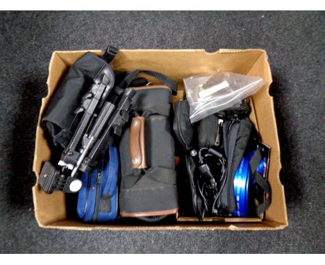 A box containing video cameras in bags, assorted cameras to include Olympus, Garmin sat nav, cased Fumoto binoculars, a Veho 