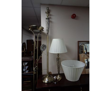 A brass standard lamp with matching table lamp together with a further brass floor lamp  