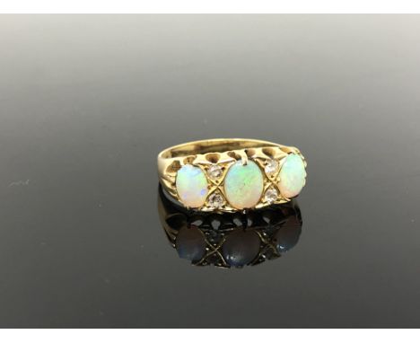 An gold opal and diamond ring, size P CONDITION REPORT: Apparently unmarked. 4.8g. One opal chipped. 