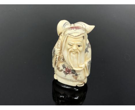 A carved Chinese netsuke  - Bearded man with sack on his back