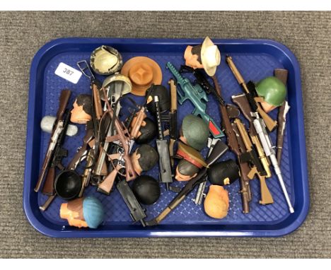 A tray of a quantity of action man heads, weapons and accessories  